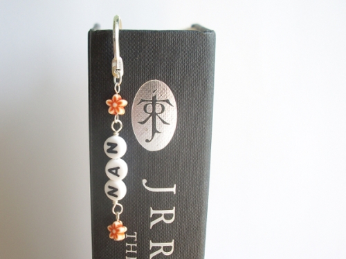 NAN in black letters & orange flowers on a wavy bookmark